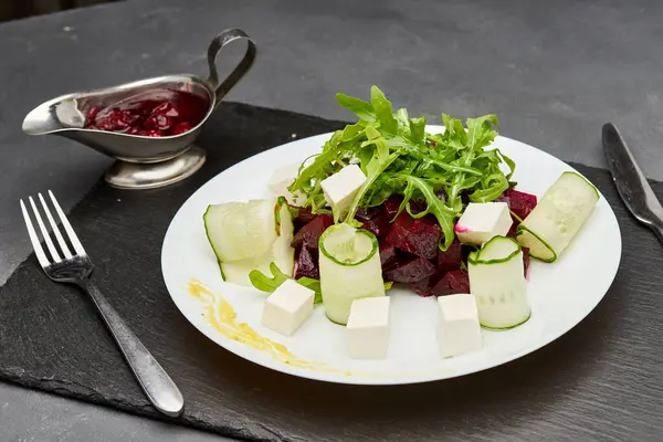 stock image Fresh beetroot salad with feta cheese, cucumber, and arugula, perfect for a light and healthy meal. High quality photo