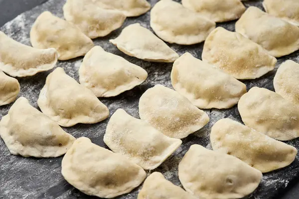 stock image Freshly prepared homemade dumplings ready for cooking, showcasing traditional culinary skills. High quality photo