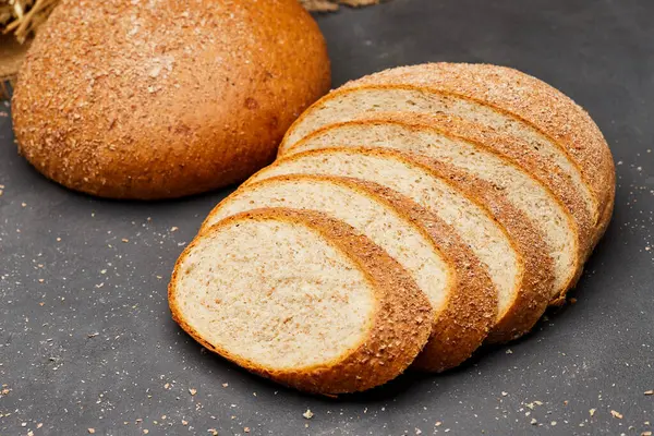 stock image Whole wheat bread loaf sliced, showcasing its hearty texture and rich, wholesome flavor. High quality photo