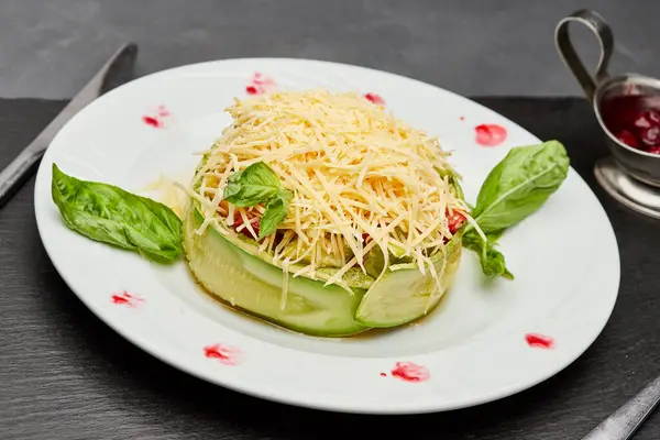 stock image Fresh zucchini salad with parmesan cheese, basil leaves, and berry sauce on a gourmet plate. High quality photo