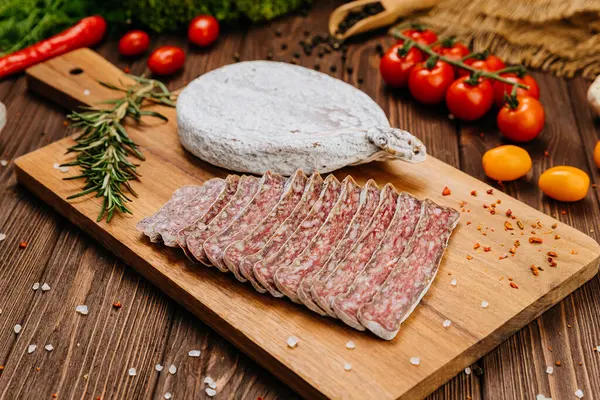 stock image Close-up of sliced dry-cured salami on board, ideal for gourmet food and charcuterie presentations. High quality photo