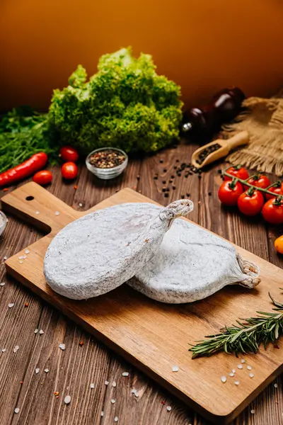 stock image Traditional dry cured sausage slices on board with spices and herbs, perfect for food photography. High quality photo