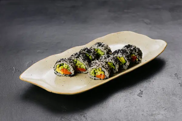 stock image Sushi rolls with black caviar and fresh vegetables, ideal for Japanese cuisine and food photography. High quality photo