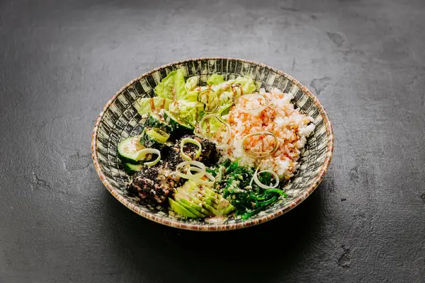 stock image Healthy poke bowl with fresh avocado, seaweed, rice, and sesame-crusted tuna - perfect balanced meal. High quality photo