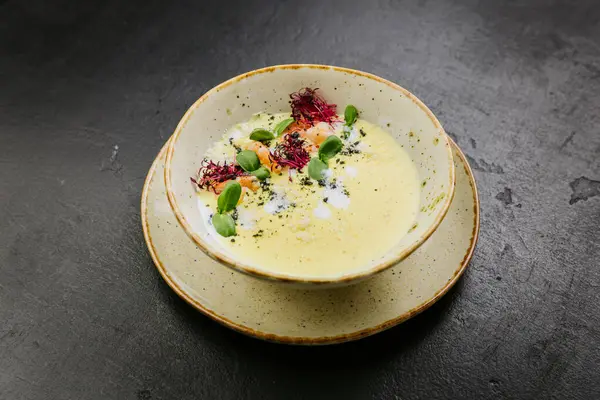 stock image Creamy gourmet soup with shrimp, microgreens, and artistic presentation - elegant fine dining dish. High quality photo