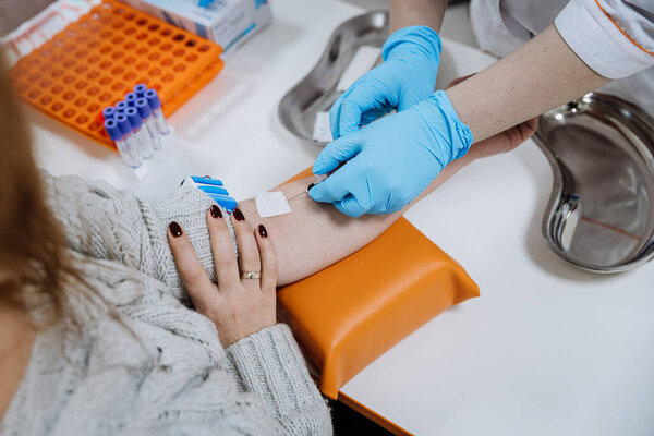 Healthcare professional drawing blood from patient for medical test. Laboratory and diagnostics. High quality photo