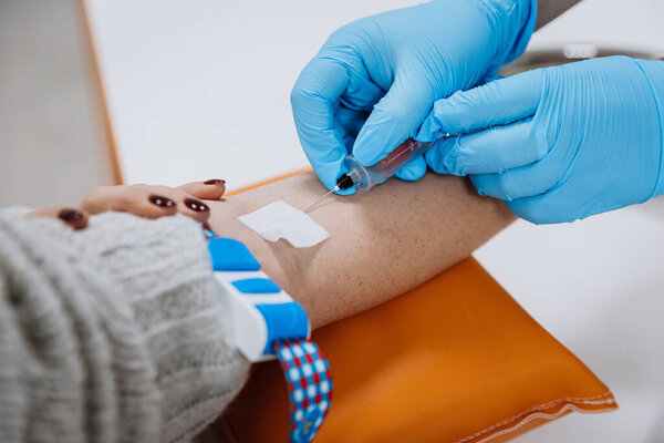 Healthcare professional drawing blood from patient for medical test. Laboratory and diagnostics. High quality photo
