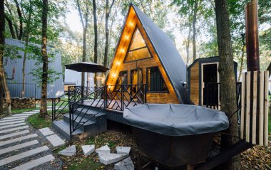 Açık verandası, saunası ve jakuzisi olan rahat bir kulübe. Huzurlu bir orman inzivası ile çevrili. Yüksek kalite fotoğraf