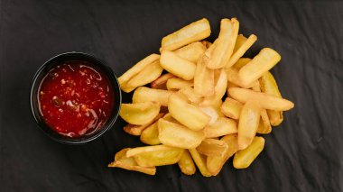 Crispy potato wedges served with ketchup, perfect snack or side dish for any meal. High quality photo clipart