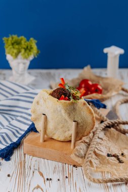 Falafel wrap with fresh vegetables and herbs in pita bread, Mediterranean street food lovers. High quality photo clipart