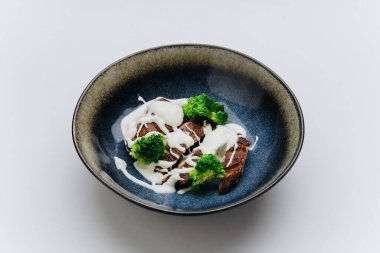 Grilled chicken with creamy sauce and broccoli, delicious combination of flavor and health. High quality photo clipart