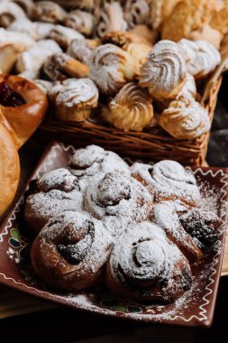 Dekoratif tabakta pudra şekerli geleneksel çörekler, tatlı severler için mükemmel. Yüksek kalite fotoğraf