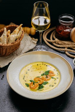 Ispanaklı kremalı karides çorbası, acı biber taneleri ve bitkisel yağla süslenmiş, gurme tarzında servis ediliyor. Yüksek kalite fotoğraf