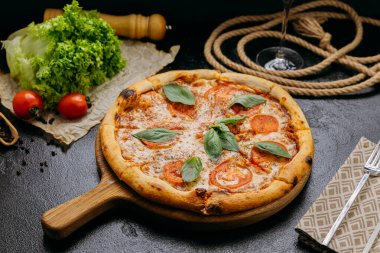 Tahta tahtada taze fesleğen, domates ve mozzarella ile klasik Margherita pizzası. Yüksek kalite fotoğraf