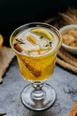 Aromatic spiced tea with orange and cinnamon in an elegant glass, creating a cozy and warm ambiance. High quality photo clipart