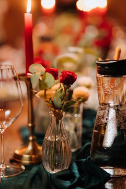 Mumlar, kırmızı güller ve zarif masada köpüklü suyla romantik bir akşam yemeği. Yüksek kalite fotoğraf