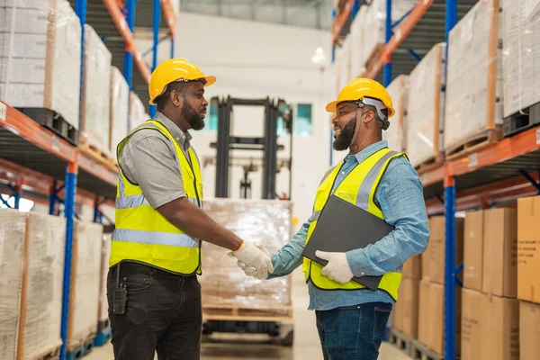 stock image Engineer and technical specialist meeting and shaking hands before checking checking the store factory, industry factory warehouse