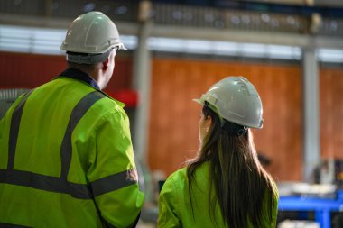 Profesyonel mühendisler depo fabrikasına girip kontrol ediyorlar. Yönetici, iç denetim için teftiş raporunu tartışıyor. Üretim için kalite güvencesi. Konsept Mühendisi.