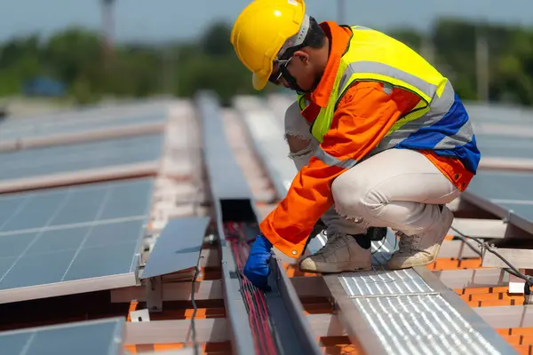 Worker Technicians are working to construct solar panels system on roof. Installing solar photovoltaic panel system. Alternative energy ecological concept. Renewable clean energy technology concept.