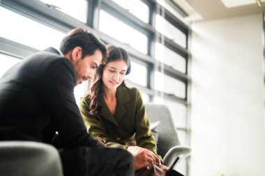 İş adamları iş yerinde eğleniyor ve sohbet ediyorlar. Erkek ve bayan meslektaşlar ortak çalışma alanında tanışmaktan hoşlanırlar. İş arkadaşlarım ofiste projeyi tartışıyorlar..