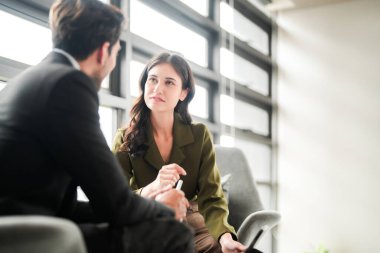 İş adamları iş yerinde eğleniyor ve sohbet ediyorlar. Erkek ve bayan meslektaşlar ortak çalışma alanında tanışmaktan hoşlanırlar. İş arkadaşlarım ofiste projeyi tartışıyorlar..