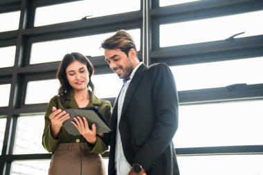 İş adamları iş yerinde eğleniyor ve sohbet ediyorlar. Erkek ve bayan meslektaşlar ortak çalışma alanında tanışmaktan hoşlanırlar. İş arkadaşlarım ofiste projeyi tartışıyorlar..