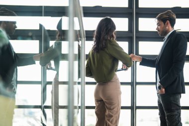 İş adamları iş yerinde eğleniyor ve sohbet ediyorlar. Erkek ve bayan meslektaşlar ortak çalışma alanında tanışmaktan hoşlanırlar. İş arkadaşlarım ofiste projeyi tartışıyorlar..