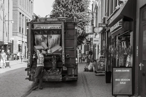 Stock image Breda, The Netherlands - 06 16 2023: Everyday life in Breda: Garbage man collects the garbage