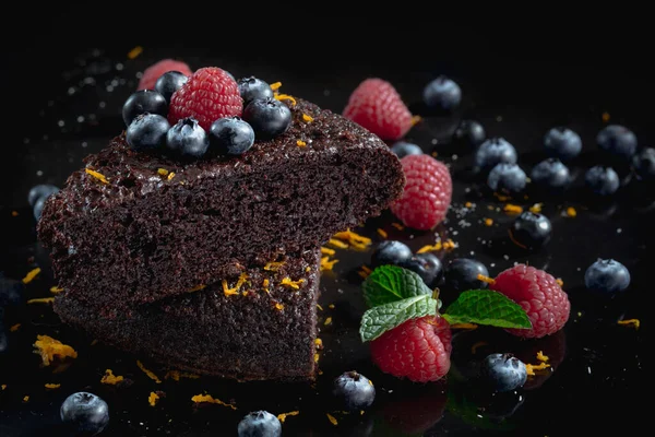 Delicious chocolate cakes on black background.