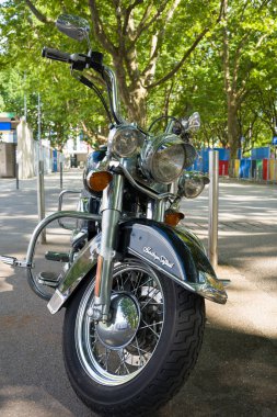 Stuttgart, Germany 14 July 2024. Harley Davidson motorcycle isolated on a white background. A black iconic motorcycle on the background of a city street. clipart