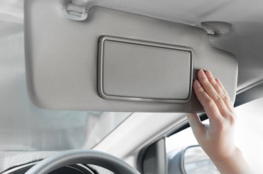 woman hand holding sun visor interior inside car clipart