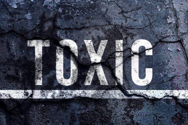 Toksik metin yazılı ve beton duvarlı beyaz çizgi, sokakta toksik işaret sözcüğü.