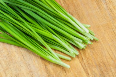 Tahta üzerinde yeşil soğanlar.