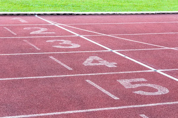 Numbers starting point on red running track,running track and green grass,Direct athletics Running track at Sport Stadium