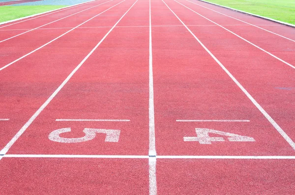 Numbers starting point on red running track,running track and green grass,Direct athletics Running track at Sport Stadium