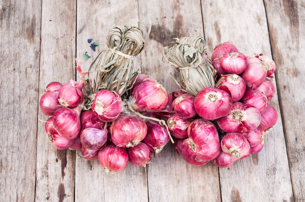 Red onions group on grunge texture wooden background,Shallot onions on wooden