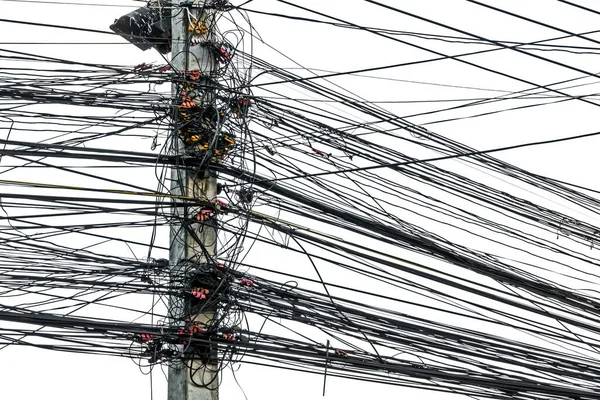 Messy chaos of cables with wires on electric pole on white background,The many Electric wire on the power poles