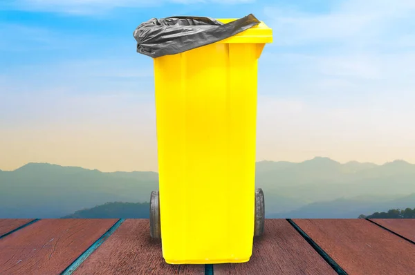 yellow Garbage bins on wooden with Landscape background