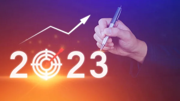 Business target and goal 2023 icon, hand pointing holding 2023 virtual screen and up arrow, Start new year 2023 with a goal plan, action plan, strategy, new year business vision.