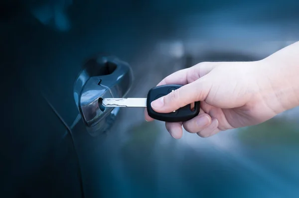 stock image opening unlocking door with car key. Car keys closeup of hand holding key to lock or unlock doors