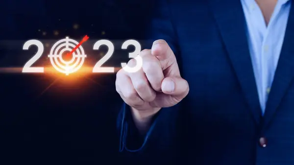 Business target and goal 2023 icon, hand pointing holding 2023 virtual screen, Start new year 2023 with a goal plan, action plan, strategy, new year business vision.