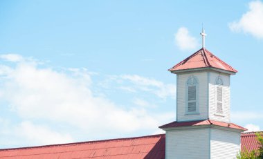 Kilise kulesi, bulutlu bir gökyüzüne karşı Hıristiyan bir ortodoks kilisesinin çatısından geçiyor.