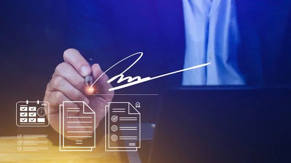 Electronic Signature Concept, Electronic Signing Businessman signs electronic documents on digital documents on virtual laptop screen using stylus pen, Paperless workplace idea.