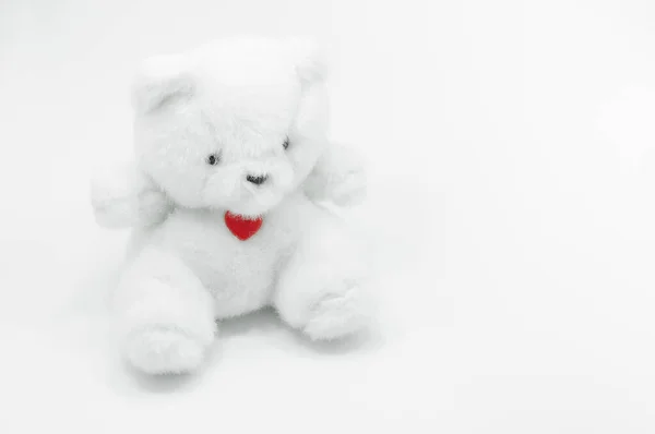 白い背景に赤い心で座っている素敵な白いテディベアのおもちゃ 恋に落ちるテディベア — ストック写真