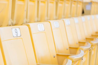 Stadyumdaki boş sarı koltuklar, futbol stadyumundaki sıralar, seçilmiş odak.