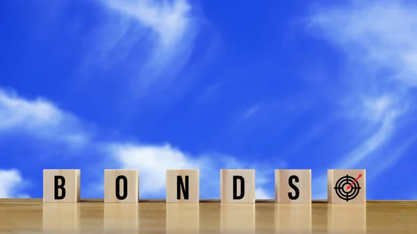Bonds word in wooden blocks with coins stacked in increasing stacks. Bonds increasing concept, investment bond concept Raising Funds to Fund the Green Bond Program