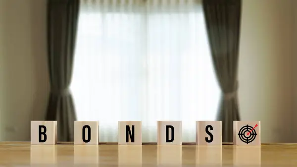Bonds word in wooden blocks with coins stacked in increasing stacks. Bonds increasing concept, investment bond concept Raising Funds to Fund the Green Bond Program