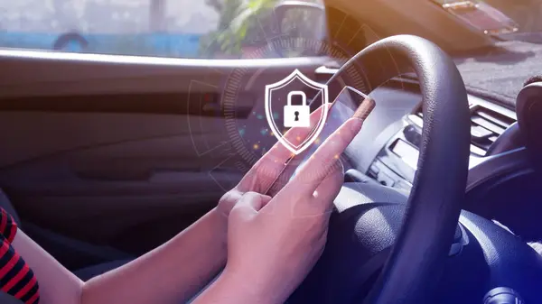 Woman driver holding smartphone with shield protection icon in car, Security shield Lock Security, Protect Concept display, secure and safe your data concept.