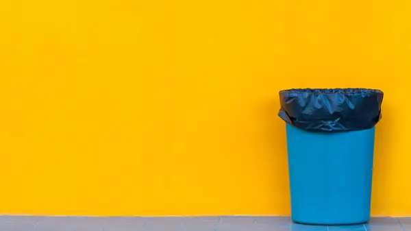 Garbage bin on yellow background, Ecological concept Reduce, reuse, recycle, ecological metaphor for ecological waste management and sustainable and economical lifestyle.