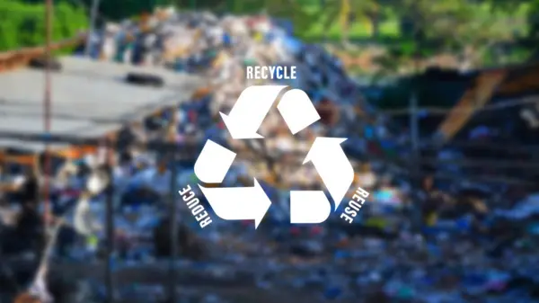 Reduce, reuse, recycle symbol on big garbage pile industry background, ecological metaphor for ecological waste management and sustainable and economical lifestyle.